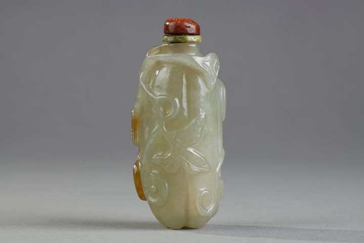 Celadon green nephrite jade snuffbottle in the shape of .pumpkin with its leaves and another small fruit in a reddish brown inclusion - China 19th century